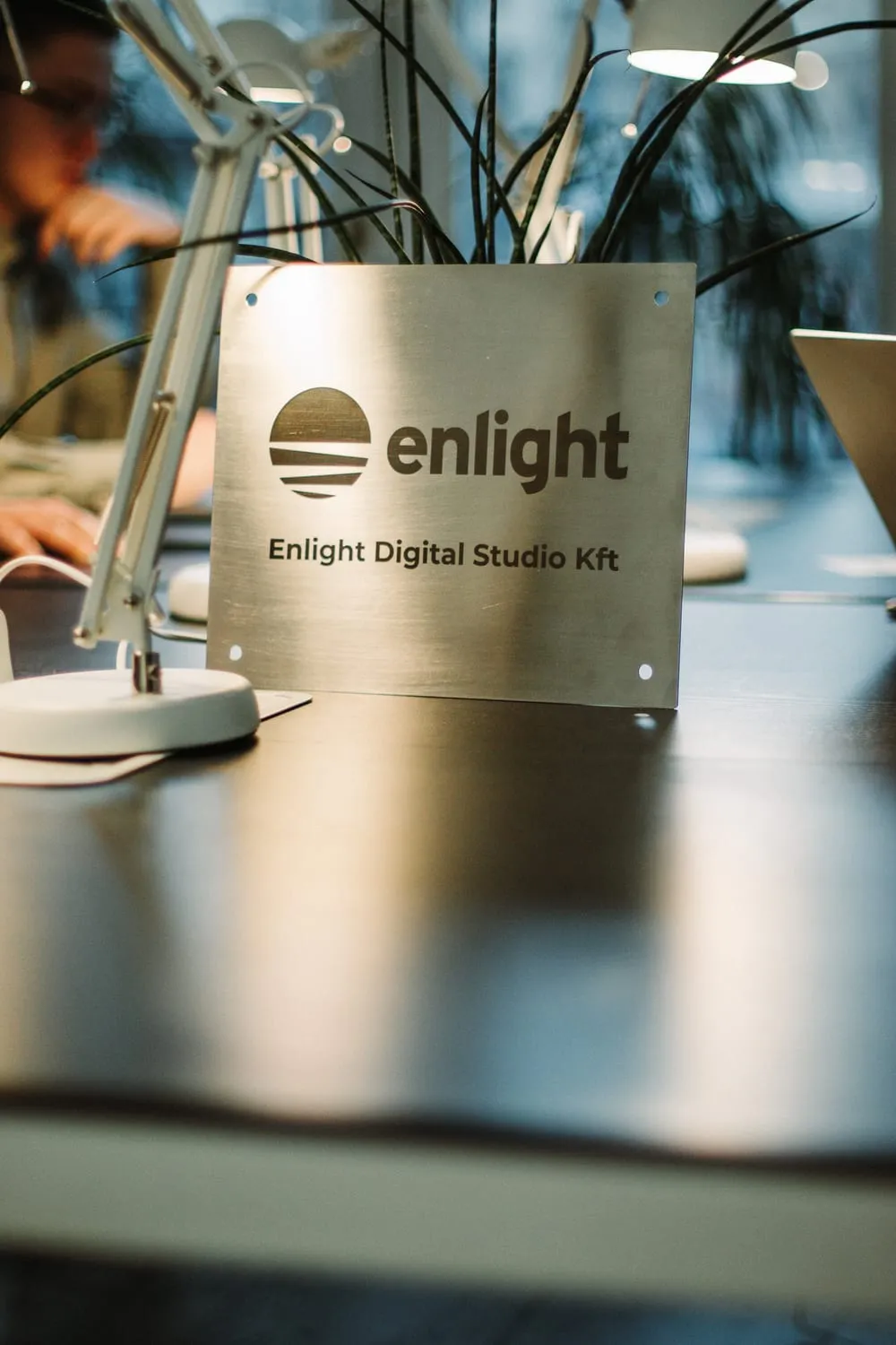 The Enlight Digital Studio Kft plaque on a desk in the office